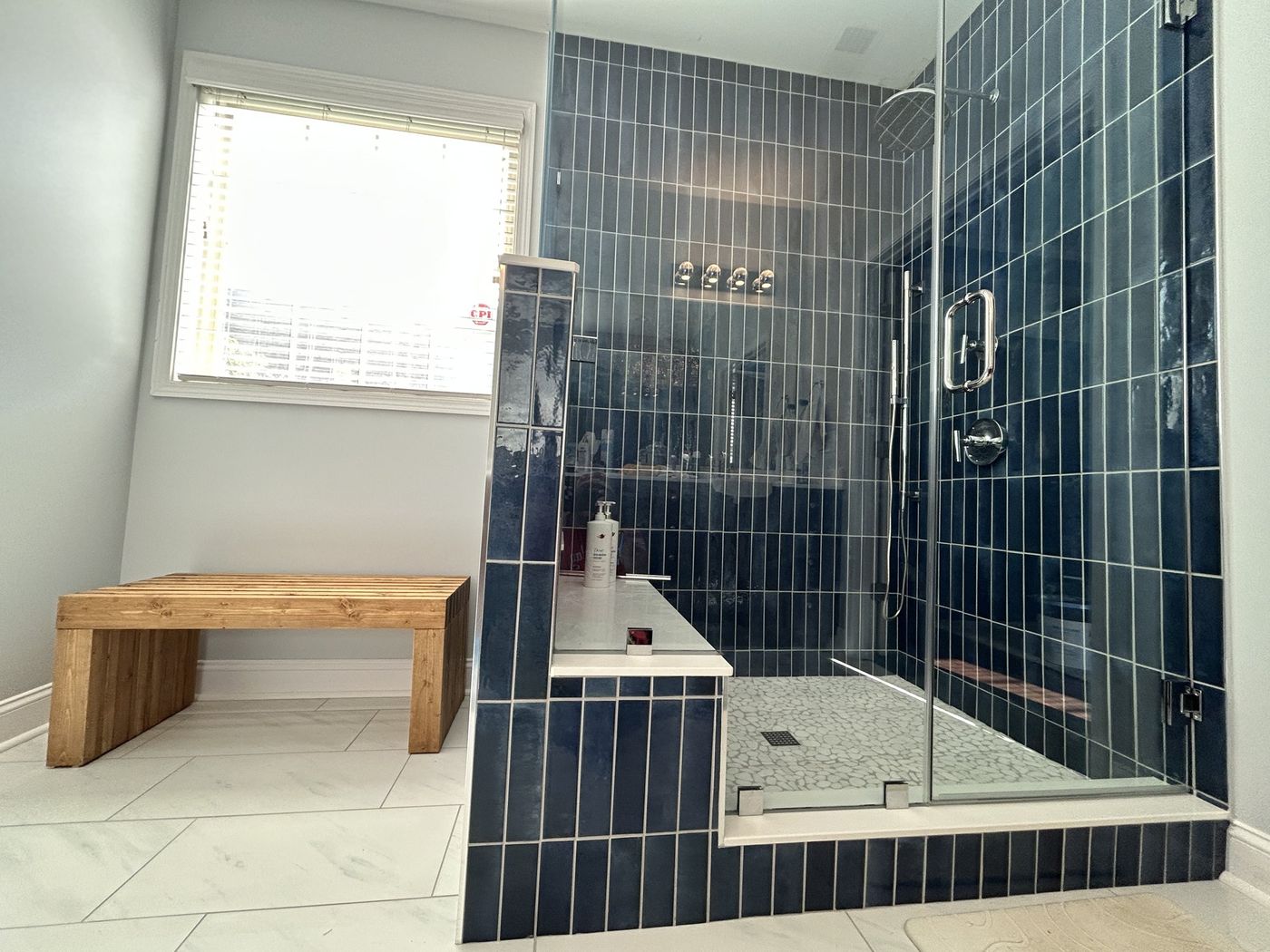 Custom navy tile shower with glass enclosure by Tile Yoda near Greenville, SC